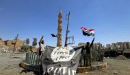 Shi'ite Popular Mobilization Forces (PMF) members hold an Islamic State flag, which they pulled down, during the war between Iraqi army and Shi'ite Popular Mobilization Forces (PMF) against the Islamic State militants in Tal Afar, Iraq August 27, 2017. Re