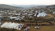 People queue outside the Brazaville voting station in Pretoria to cast their votes during South Africa's national and provincial elections on May 8, 2019.  / AFP / Phill Magakoe
 