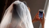 A Chinese bride takes a self portrait before her symbolic wedding in Fuessen, May 31, 2012. Reuters/Michael Dalder