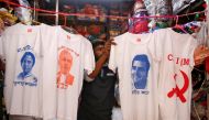 A worker displays T-shirts with images of Mamata Banerjee Narendra ModiM Rahul Gandhi and logo of CPI-M for sale inside a shop in Kolkata, India, March 26, 2019. Reuters / Rupak De Chowdhuri