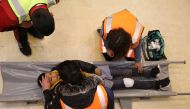 Volunteers conduct a first-aid check on a student during a safety drill at ATakmiliyat Al Kobba 2nd School in Tripoli, Lebanon, March 28, 2019. Thomson Reuters Foundation/Heba Kenso