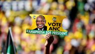 A supporter holds a placard with the face of President of South Africa's governing African National Congress Cyril Ramaphosa, during the party's final rally at Ellis Park Stadium in Johannesburg, South Africa, May 5, 2019. (REUTERS/Siphiwe Sibeko/File Pho
