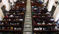 Sri Lankan Catholic devotees pray during a mass at the St. Theresa's church as the Catholic churches hold services again after the Easter attacks in Colombo on May 12, 2019. / AFP / LAKRUWAN WANNIARACHCHI 