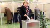 A voter casts her ballot during the first round of the presidential election at a polling station in Vilnius on May 12, 2019.   AFP / Petras Malukas