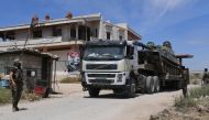 Syrian army forces enter the town of Kafr Nabuda, about 40 kilometres north of Hama, on May 11, 2019. / AFP / George OURFALIAN