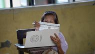 An elderly woman casts her vote for the mid-term elections at a polling precinct in Manila on May 13, 2019. AFP / TED ALJIBE