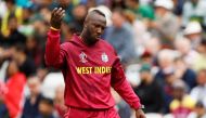 West Indies' Andre Russell signals for treatment. Reuters/Jason Cairnduff