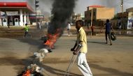 A disabled man walks past a barricade erected by Sudanese protesters along a street, demanding that the country's Transitional Military Council hand over power to civilians, in Khartoum, Sudan June 3, 2019. REUTERS/Stringer TPX IMAGES OF THE DAY