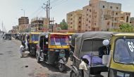 Sudanese drivers wait to fill their tuk-tuk at a petrol station amid a fuel shortage in the capital Khartoum on June 6, 2019. AFP