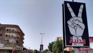 Picture taken on June 6, 2019 shows Street 60 nearly deserted in the capital Khartoum. Hanging placards read in Arabic 