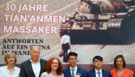 Juergen Trittin and other politicians of the German Green Party pose for media with Hong Kong activists Ray Wong and Alan Li at a party event in the German Parliament to mark the 30th anniversary of the Tiananmen Massacre in Berlin, Germany, June 4, 2019.