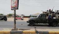 Sudanese security forces drive through the main road linking Omdurman with its twin city Khartoum on the first day of a civil disobedience campaign across Sudan on June 9, 2019.  AFP 