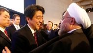 FILE PHOTO: Japan's Prime Minister Shinzo Abe greets Iran's President Hassan Rouhani (R) during the annual meeting of the World Economic Forum (WEF) in Davos January 22, 2014. REUTERS/Denis Balibouse/File Photo