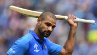 India's Shikhar Dhawan raises his bat to the crowd as he walks back to the pavilion after his dismissal during the 2019 Cricket World Cup group stage match between India and Australia at The Oval in London on June 9, 2019. AFP / Dibyangshu Sarkar 