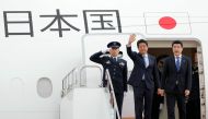 Japan's Prime Minister Shinzo Abe (C) waves to well-wishers upon his departure at Tokyo's Haneda Airport on June 12, 2019. Abe left for a two-day visit to Iran. - Japan / AFP / JIJI PRESS / JIJI PRESS