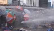 Protesters are hit by police water cannon during a demonstration against a proposed extradition bill in Hong Kong, China June 12, 2019. REUTERS/Tyrone Siu