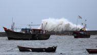 Waves crash against the jetty at a fishing harbour ahead of the expected landfall of Cyclone Vayu at Veraval, India, June 12, 2019. REUTERS/Amit Dave