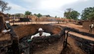 A man is seen inside a burnt house during clashes between nomads and residents in Deleij village, located in Wadi Salih locality, Central Darfur, Sudan June 11, 2019. Reuters