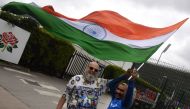 Indian cricket fan Sudir Gautam (R) and Pakistani cricket fan Mohammad Bashir wave the Indian tricolour at Old Trafford Cricket Stadium in Manchester on June 15, 2019, ahead of the 2019 World Cup match between India and Pakistan. AFP / Dibyangshu Sarkar 
