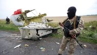 FILE PHOTO: A pro-Russian separatist stands at the crash site of Malaysia Airlines flight MH17, near the village of Hrabove (Grabovo) in Donetsk region, Ukraine, July 18, 2014. REUTERS/Maxim Zmeyev/File Photo