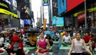 Yogis participate in a yoga class during the annual Solstice in Times Square event in New York, U.S., June 21, 2019. Reuters/Shannon Stapleton