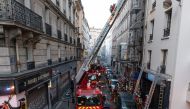 Firefighters working on the site of a fire that broke out in a building rue de Nemours in Paris, where three people died and another was seriously injured in a fire that broke out early in the morning.