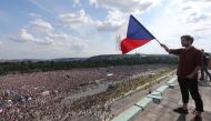 A demonstrator waves a Czech Republic flag during a protest rally demanding resignation of Czech Prime Minister Andrej Babis in Prague, Czech Republic, June 23, 2019. REUTERS/Milan Kammermayer