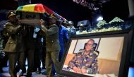 Members of the army carry one of the coffins covered with the Ethiopian national flag as they arrive at the millennium hole in Addis Ababa, on June 25, 2019 for the National funeral service of Chief of Staff of the Ethiopian defence forces Seare Mekonnen 