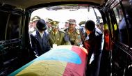 Members of the army carry one of the coffins covered with the Ethiopian national flag as they arrive at the millennium hole in Addis Ababa, on June 25, 2019 for the National funeral service of Chief of Staff of the Ethiopian defence forces Seare Mekonnen 