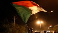 FILE PHOTO: Sudanese people, seeking to revive a push for civilian rule in ongoing tumult since the overthrow of former President Omar al-Bashir more than two months ago, chant slogans and wave Sudanese flags during a demonstration in Khartoum, Sudan, Jun