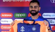 India's captain Virat Kohli poses with his new team colours during a press conference at Edgbaston in Birmingham, central England on June 29, 2019, ahead of their 2019 Cricket World Cup group stage match against England. AFP / Dibyangshu Sarkar 