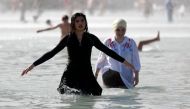 Two girls cool themselves down in the Trocadero Fountain near the Eiffel Tower in Paris during a heatwave on June 28, 2019. The temperature in France on June 28 surpassed 45 degrees Celsius (113 degrees Fahrenheit) for the first time as Europe wilted in a