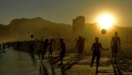 Beachgoers play with balls at Ipanema Beach in Rio de Janeiro, Brazil, on June 29, 2019. Tourists from all over Latin America have arrived in Rio for the Copa America football tournament. AFP / Carl De Souza 