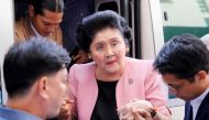 File photo of Aides help former Philippine First Lady Imelda Marcos walk, as she arrives at an anti-corruption court Sandiganbayan, to attend a court hearing in Quezon City, Metro Manila, in Philippines November 16, 2018. REUTERS/Eloisa Lopez