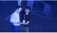 This framegrab taken from AFPTV shows a man (R) pouring water Baidu co-founder and CEO Robin Li during Baidu Create 2019 in Beijing on July 3, 2019. AFP / AFPTV / QIAN Ye
