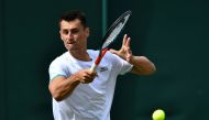 Australia's Bernard Tomic returns against France's Jo-Wilfried Tsonga during their men's singles first round match on the second day of the 2019 Wimbledon Championships at The All England Lawn Tennis Club in Wimbledon, southwest London, on July 2, 2019. A