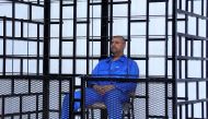 Saif al-Islam Gaddafi, son of late Libyan leader Muammar Gaddafi, attends a hearing behind bars in a courtroom in Zintan May 25, 2014. Reuters