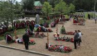 People attend the funeral of Russian sailors, who were recently killed in a fire on a secret nuclear research submarine in the area of the Barents Sea, at Serafimovskoye cemetery in Saint Petersburg, Russia July 6, 2019. (REUTERS/Anton Vaganov)