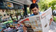 An Iranian man reads a local newspaper in the capital Tehran on July 8, 2019. AFP / Str