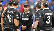New Zealand's captain Kane Williamson (C) and teammates wait for a review decision during the 2019 Cricket World Cup first semi-final between New Zealand and India at Old Trafford in Manchester, northwest England, on July 10, 2019. New Zealand beat India 