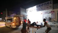 An injured man is evacuated from the scene where a suicide car bomb exploded targeting a hotel in a business center in Maka Al Mukaram street in Mogadishu, Somalia, February 28, 2019. Reuters/Feisal Omar