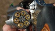 The clip shows the boy being shown how to load bullets into the revolver. The man then hands the gun to his son with the barrel pointed towards the boy. (Photo courtesy: Gun Digest)  