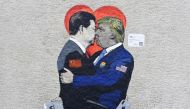 Smart Love by Italien street artist TvBoy depicts iPhone holding Xi Jinping kissing Huawei smartphone holding Donald Trump, in Milan on June 29, 2019. AFP/Miguel Medina