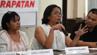 Tinay Palabay (2nd R) of Karapatan, an alliance for the advncement of people's rights, speaks during a press confence in Manila on July 13, 2019, a day after the United Nations Human Rights Council approved a resolution mandating a comprehensive internati