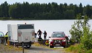 An emergency services boat carrying wreckage parts of a small airplane at a small harbor near the accident site at Ume river outside Umea, Sweden on July 14, 2019. AFP / TT News Agency / Samuel Petterson
 