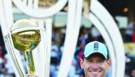 England's captain Eoin Morgan poses with the World Cup trophy as England's players celebrate their win after the 2019 Cricket World Cup final between England and New Zealand at Lord's Cricket Ground in London on July 14, 2019.  AFP / Glyn Kirk 