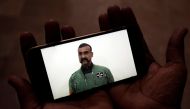 FILE PHOTO: A man watches a statement of Indian Air Force pilot Abhinandan Varthaman on his mobile phone, released on twitter by the Ministry of Information and Broadcasting in Karachi, March 1, 2019. Reuters/Akhtar Soomro