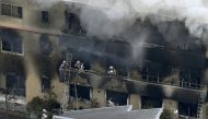 An aerial view shows firefighters battling the fires at the site where a man started a fire after spraying a liquid, at a three-story studio of Kyoto Animation Co. in Kyoto, western Japan, in this photo taken by Kyodo July 18, 2019. Kyodo/via Reuters