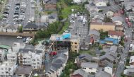 This aerial view shows the rescue and recover scene (C) after a fire at an animation company building killed some two dozen people in Kyoto on July 18, 2019. (AFP / JIJI PRESS)