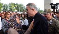 Turkish National Defense Minister Hulusi Akar condoles with Sidika Kose (L), mother of Turkish diplomat Osman Kose, who was martyred in an armed attack in Iraq's Erbil, during the funeral ceremony at Ahmet Hamdi Akseki Mosque in Ankara, Turkey on July 18,